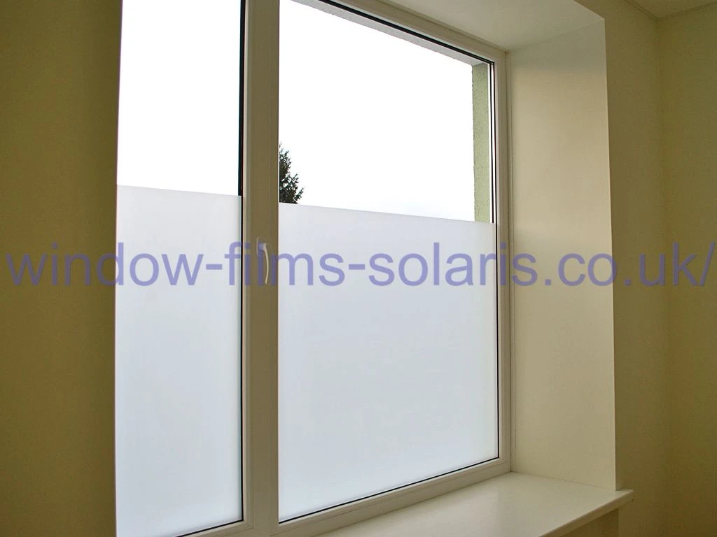 Home window covered with white matte privacy film